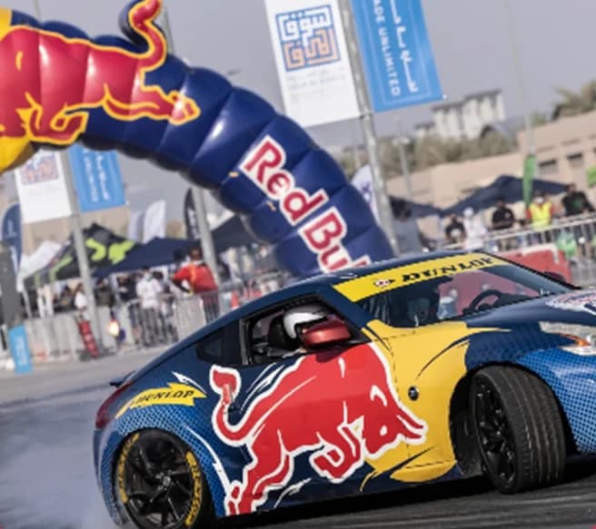 Red Bull Car Park Drift — Drift car passing beneath an inflatable arch